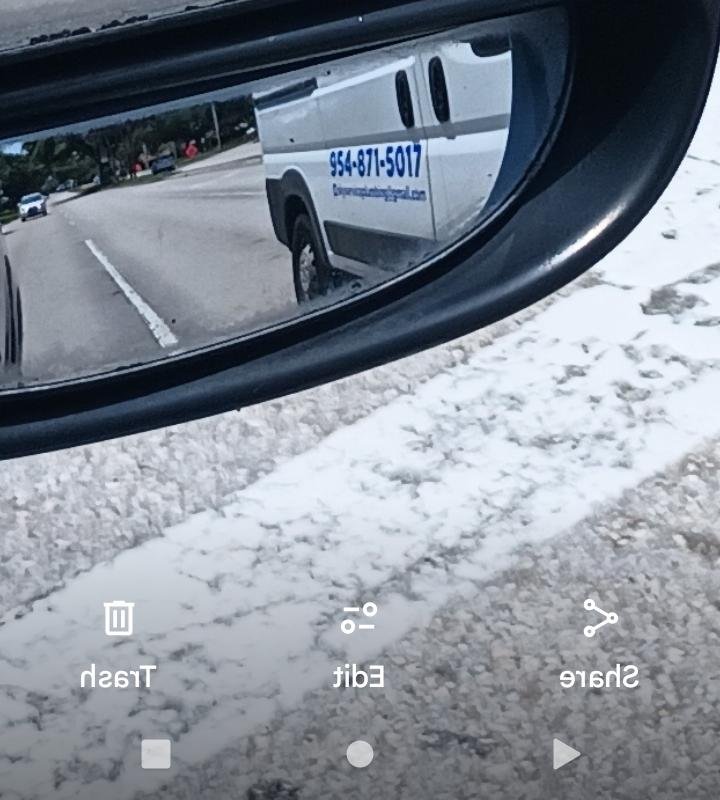 DW Service Plumbing van captured in side mirror reflection on Nob Hill Road Plantation FL