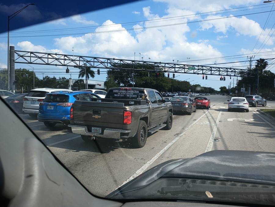 United General Construction tailgate sign in traffic on Pine Island Road